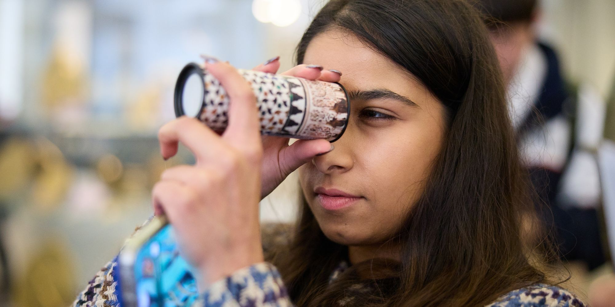 Woman looking at kaleidoscope