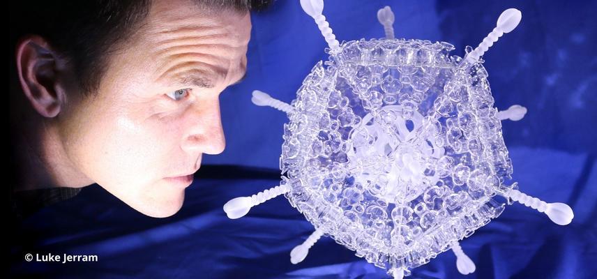 Luke Jerram with his COVID-19 vaccine glass sculpture